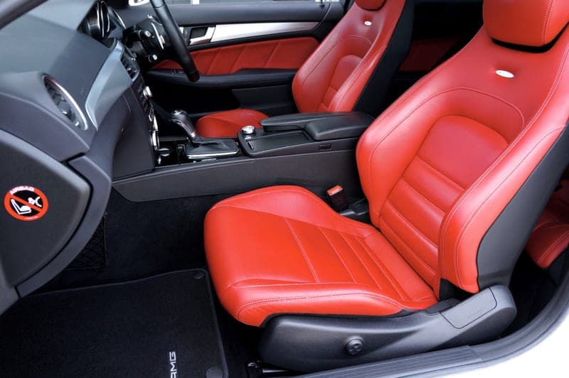 A car footwell with a rubber all-weather mat in place - a stand-in for the Armor All 4-Piece Rubber Floor Mat Set, not a photograph of this model